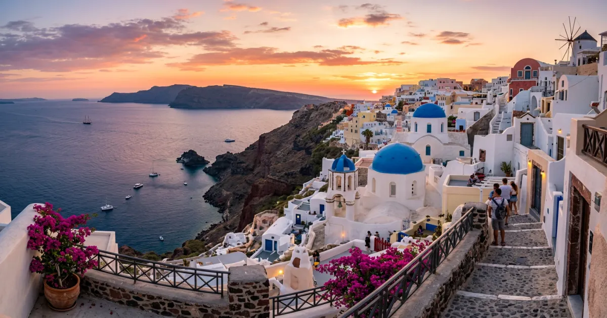 Santorini blue domes and caldera at sunset - planning a trip to Greece